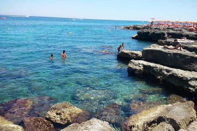 The cove of low rocks with clear water for swimming