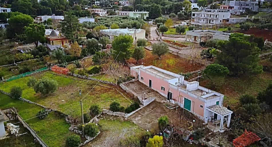 The property today from the air: the pink house, the dry-stone walls and the four thousand square metres of land